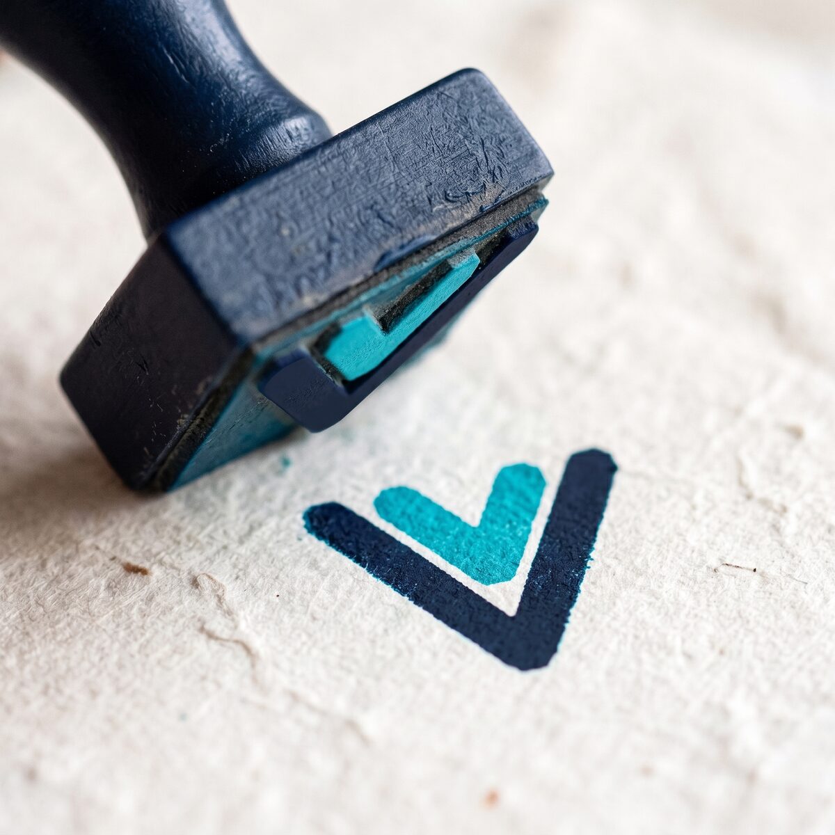 The Zaaf mark stamped in cyan and navy ink on paper
